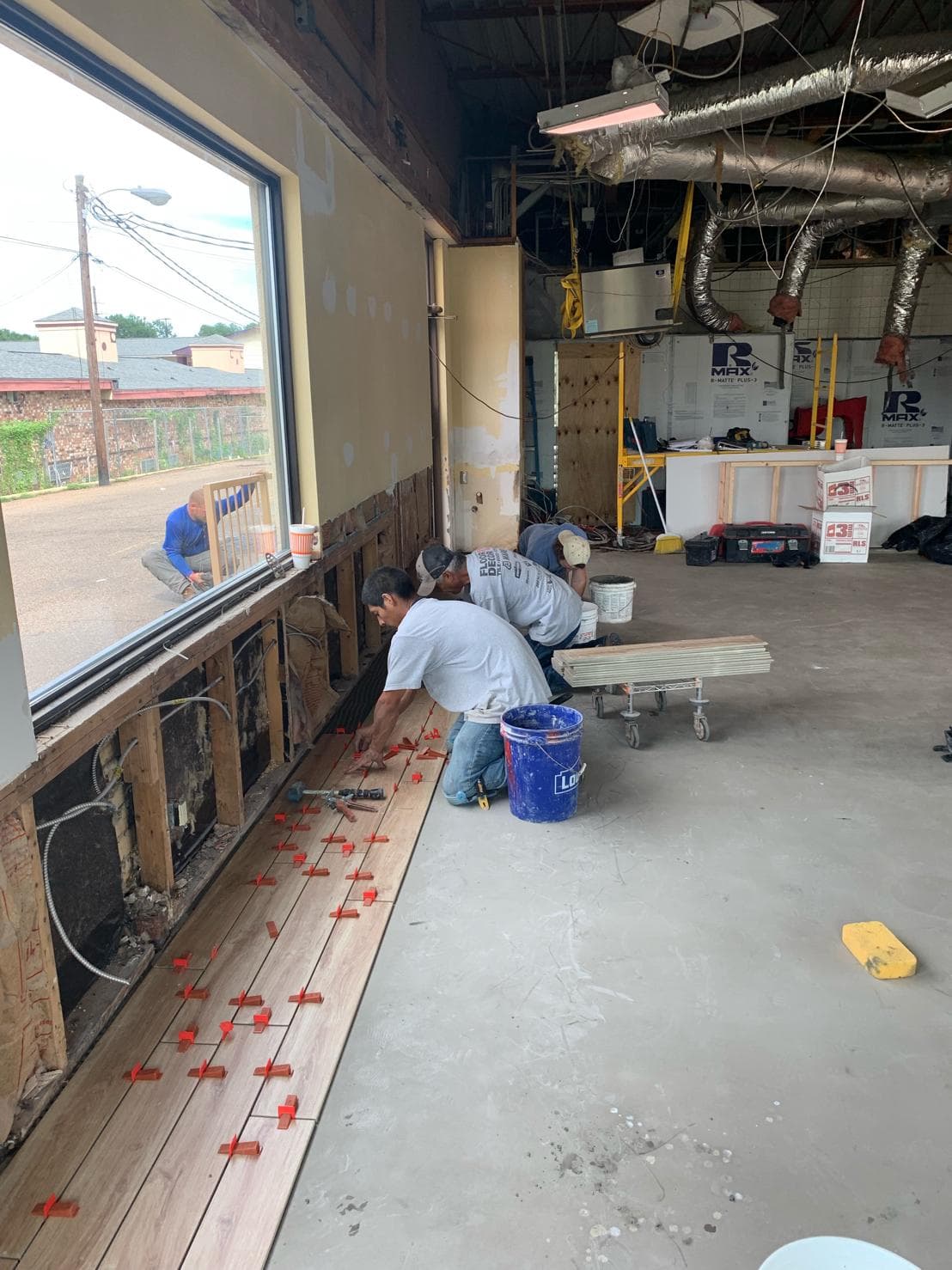Tile installation in progress — Sisson Tile crew on active commercial job site by Sisson Tile