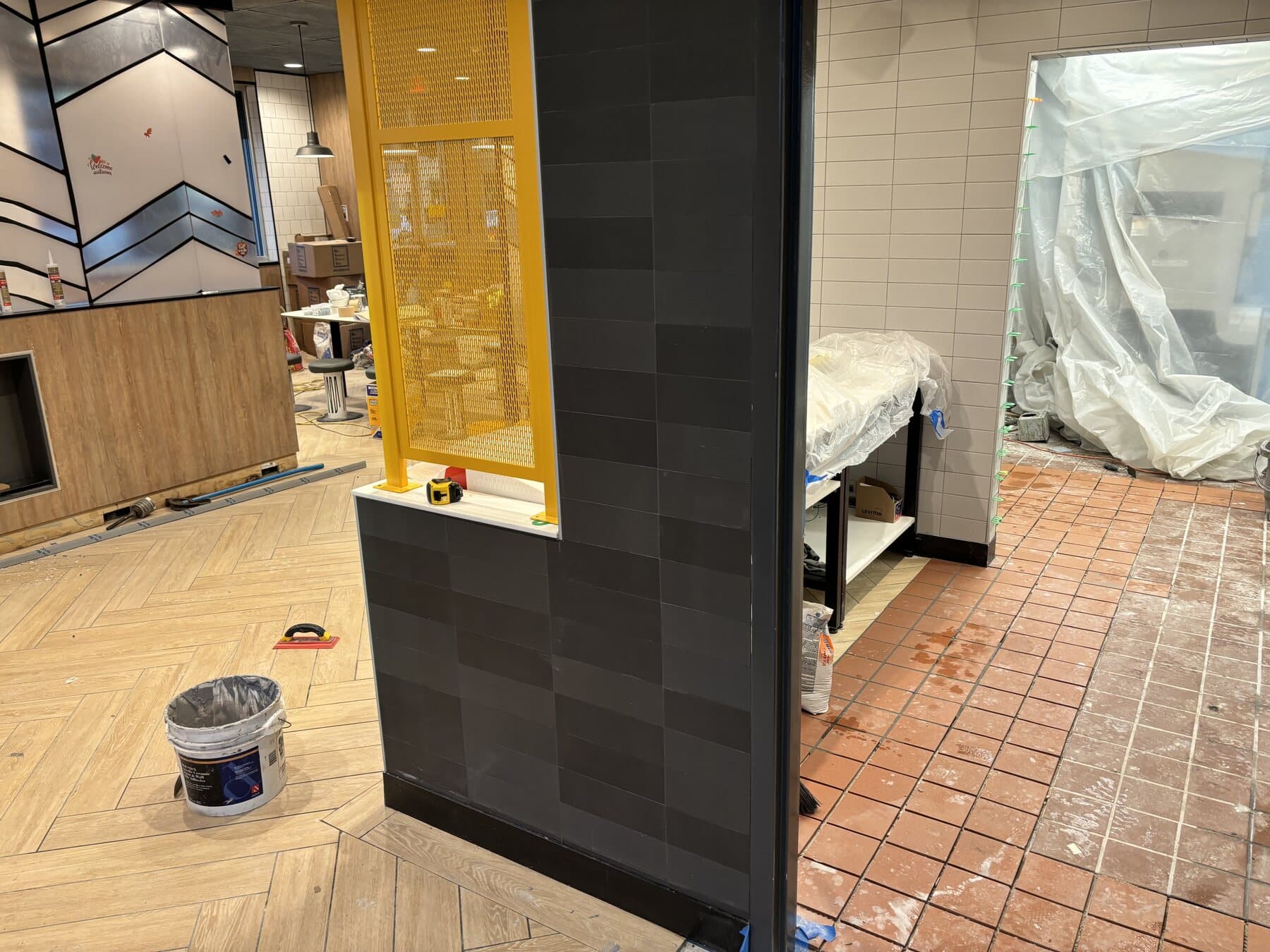 Tile installation in progress — Sisson Tile crew on active commercial job site by Sisson Tile