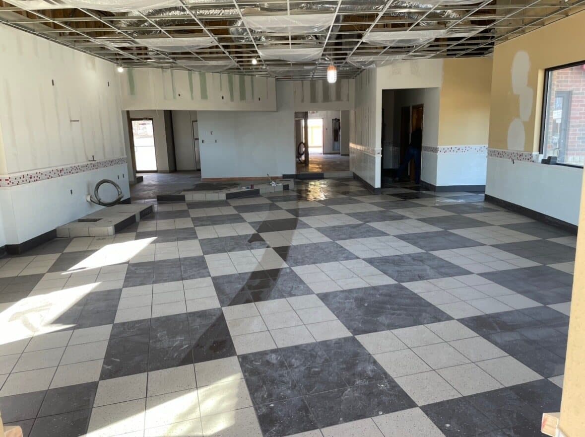 Tile installation in progress — Sisson Tile crew on active commercial job site by Sisson Tile